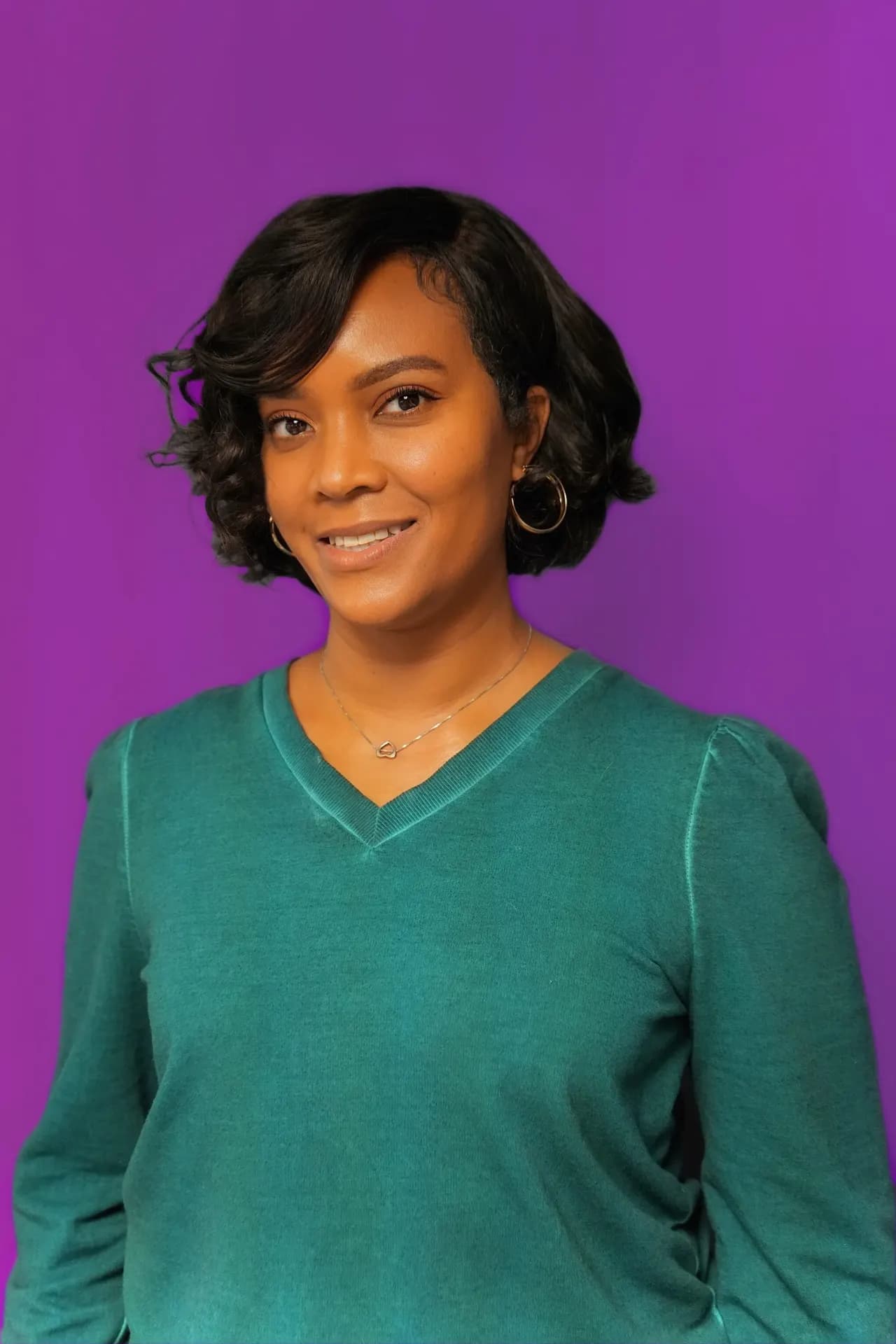 Studio headshot with clean purple background